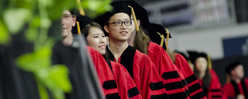 Students participate in the doctoral hooding ceremony